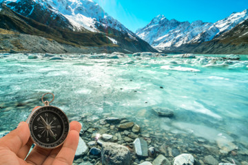 Compass with natural blur background. Travel concept.