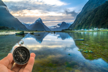 Compass with natural blur background. Travel concept.
