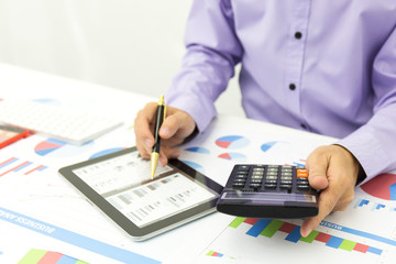 Businessman using a personal income tax calculator.