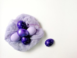 colored eggs on a textured white background 
