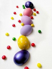 colored eggs on a textured white background 