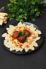 Farfalle Pasta. Homemade Pasta with Meat Balls and Sauce. Black Board. Vertical Image.