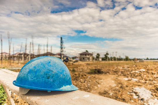 Blue hard hat on house building construction site