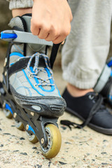 Woman putting on roller skates outdoor.