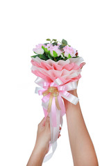 Woman hands holding artificial pink roses bouquet isolated on white background.