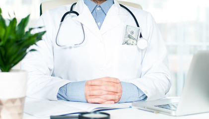 Doctor with money in his pocket
