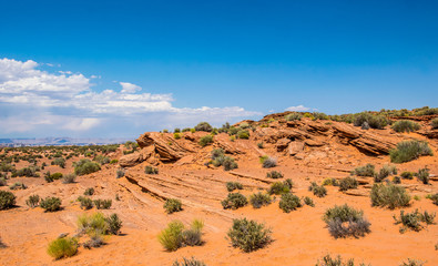 Desert rocky landscape of the southwest of the USA. Red weathered stones and blue sky