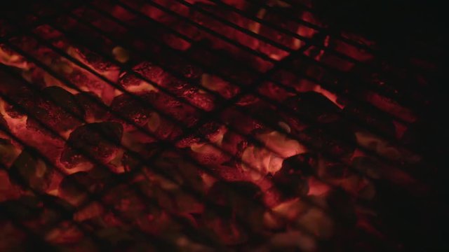 Close up of the glowing hot charcoal briquettes.