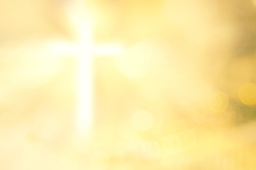 Blurred cross over bokeh golden yellow light background