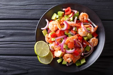 Fotobehang Delicious ceviche of shrimp with vegetables, spices and lime close up on a plate. horizontal top view © FomaA