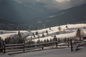 winter in the mountains - small Romanian village in the Carpathians covered with snow