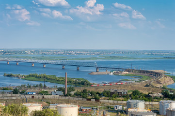 a fragment of a railway bridge across the Volga River, with a train at the entrance to it