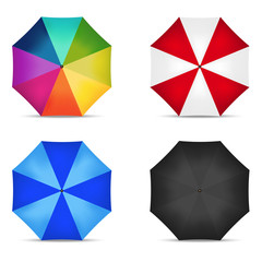 Set of four open multicolored umbrellas on white background