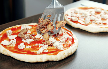 mushrooms for pizza, scapula for food, cooking, meat of chiken, thick dough,  pizza crust, chef prepares delicious pizza at home, pizza with chicken and mushrooms, cooking process, champignon