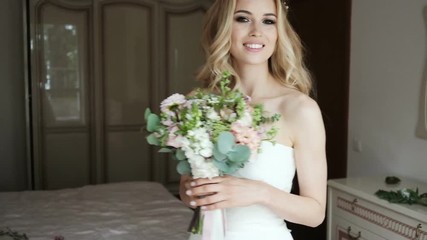 Happy bride smiling at the camera. Beautiful bride portrait wedding makeup and hairstyle. Beauty portrait of young woman at morning.