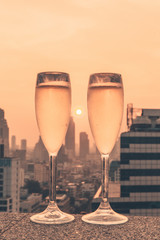 Champagne glasses with a sunset in Bangkok