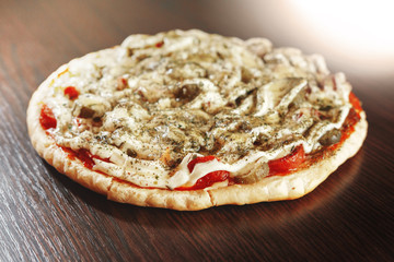 ready pizza is on the table, dark table, thick pizza, many ingredients, homemade food, close-up