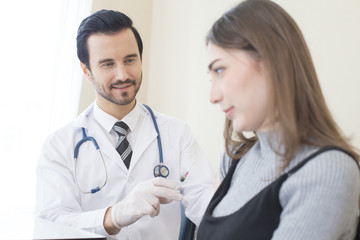 Fototapeta premium Doctor inject woman at hospital. People with medical concept.