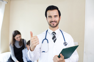 Doctor looking to camera with attractive smiling and patient background. People with medical concept.