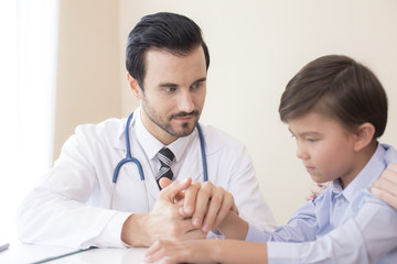Attractive Doctor working at hospital. Doctor try to treat Kid for any problem.