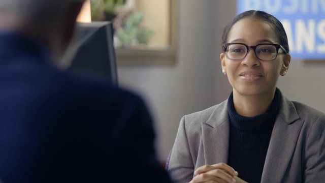 Female banker talking to client about a business loan