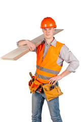 builder in a helmet holding floorboards and looking at camera over white wall background. repair, construction, building, people and maintenance concept.