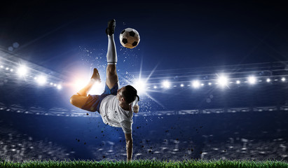 Soccer player at stadium. Mixed media