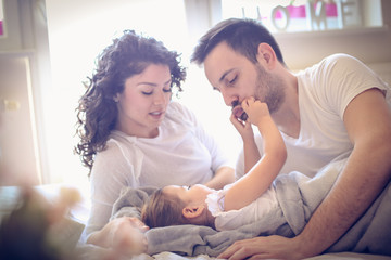 Fototapeta premium Play with daddies moth make me laugh. Little girl morning.