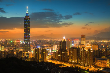 Fototapeta premium Panoramę miasta Tajpej o zachodzie słońca i słynny Taipei 101 w tle