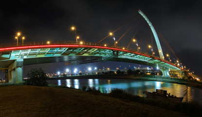 Dazhi bridge at night with lights relfecting in the water, Taipei, Taiwan