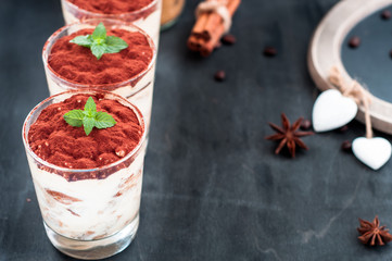 tiramisu luxury dessert in a glass with mint on a black background