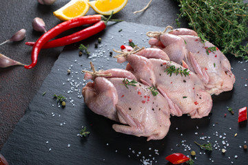 Raw uncooked seasoned partridges .Ingredients for cooking healthy meat dinner.