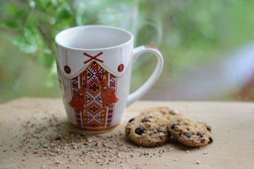 a cup of coffee with  cookies