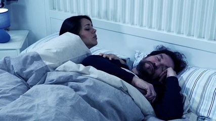 Woman at night not able to sleep husband snoring strong slow motion closeup