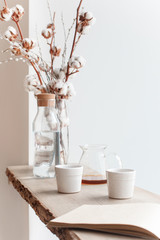 Cup of coffee, branch of tree, wooden windowsill