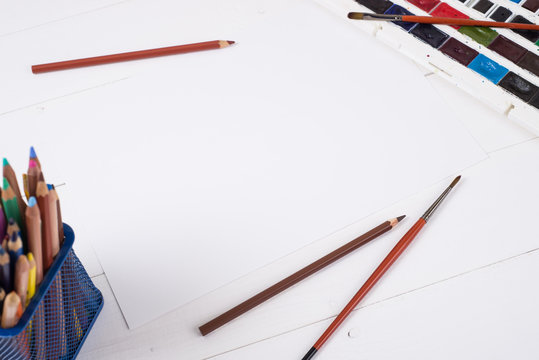 Paints, pencils and brushes on wooden to a floor. Image preprocessing