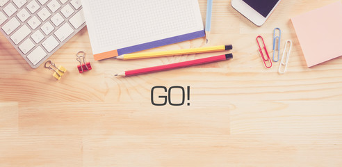 Business Workplace with  GO! Concept on Wooden Background