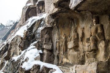Fototapeta na wymiar Close-up Stone Buddha Statue Carved from the mountains in winter