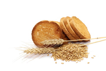 Rusks with integral wholewheat flour, bread slices, ears of wheat and grains isolated on white...