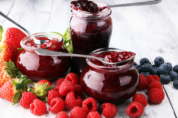 assortment of jams, seasonal berries, mint and fruits