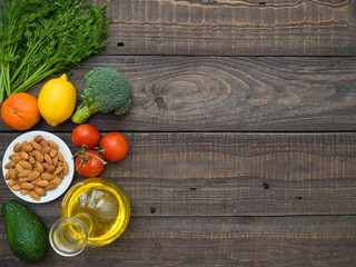 Decanter with sunflower oil, fruits and vegetables on a wooden table