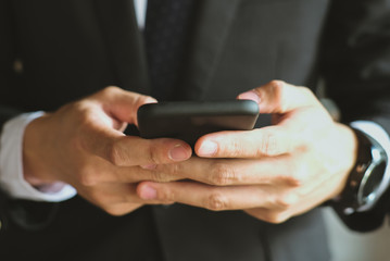 businessman holding smartphone & using app. man texting message outdoors. social network communication, wireless connection, lifestyle concept