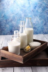 milk products. tasty healthy dairy products on a table on. sour cream in a bowl, cottage cheese bowl, cream in a a bank and milk jar, glass bottle and in a glass