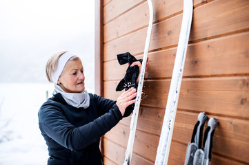 Senior woman getting ready for skiing.