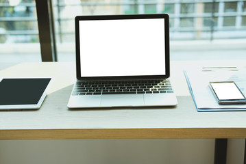 smartphone on document at office. computer laptop on wood desk at workplace.