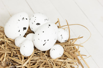 Quail eggs on the hay. Easter background 