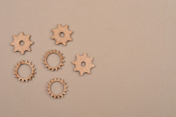 Wooden gear on cardboard