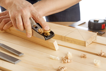 DIY concept. Woodworking and crafts tools. Carpentry hand tools. Planers, chisels, saw, measuring tools. Craftsman makes a wooden parts. Wooden background. Isolated on white