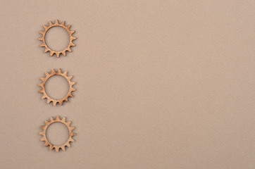 Wooden gear on cardboard
