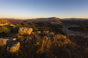 Sunset panorama taken from Byllis village - view of landscape with stones, river band and mountains in the background, Byllis, Fier Country, Albania, Europe